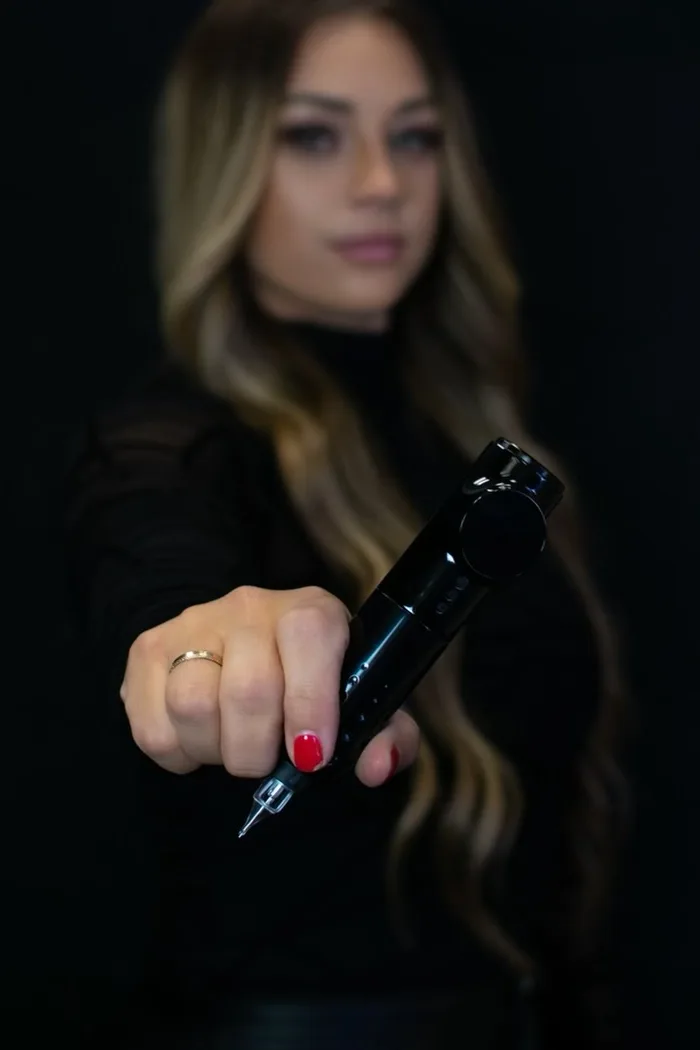 Britteni holding the pigment machine she works with