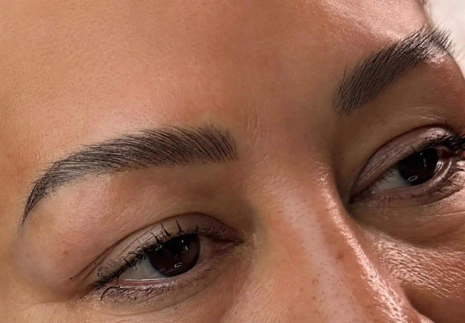 Healed permanent brows with fine, natural hair strokes